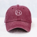 Close-up of white face embroidery on vintage washed burgundy cotton baseball cap - One Size / Burgundy
