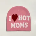 Detailed knit texture of pink beanie featuring white I heart Hot Moms jacquard lettering - Moms Style / Pink
