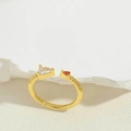 Macro detail of 14K gold-plated open ring with triangular zircon and ruby gemstones - Triangle Red & White Stone Style