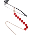 Detailed macro of red crystal beads and gold metal chain on a 10mm eyewear strap - Red