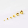 Macro shot of 18k gold plated round spacer beads in six different size specifications - 2mm / Gold