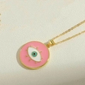 Detail view of pink evil eye pendant necklace with golden chain on stone surface - Pink Enamel Pendant (XL2982-2)