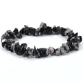 Detailed close-up of irregular black obsidian and snowflake stone elastic beaded bracelet - Snowflake Obsidian
