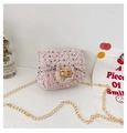 Close-up of pink tweed crossbody bag with golden chain and twist lock detail - Pink