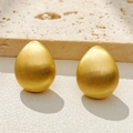 Minimalist gold teardrop earrings with brushed metal finish on natural stone background - Gold