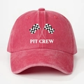 Close-up of washed cotton racing baseball cap with Pit Crew print and checkered flags - Watermelon red