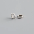 Macro shot of S925 sterling silver huggie earrings with shimmering cubic zirconia inlay - Outer Diameter 8mm / Silver
