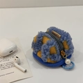 Detail of blue and yellow checkerboard plush case for AirPods with pearl keychain - Blue Plaid