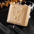 Close-up of double-layer necklace with pearls, star and moon pendants on beige jewelry box - Star Moon Style