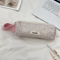 Detailed view of floral canvas stationery bag with pink handle and metal zipper closure - Twill Flowers