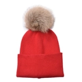 Detail of red cable knit kids beanie featuring a fluffy brown faux fur pom pom top - One Size / Red