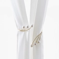 Elegant gold metal curtain tieback with white pearls on a sheer white fabric background - Korean Style Pearl Tieback