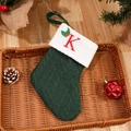 Green knitted Christmas stocking with red letter K embroidery and white cuff trim - Letter K