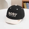 Close-up of black and white kids baseball cap with BOBY embroidery and side woven label - 50cm (1-3 Years) / Black