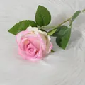 Artificial pink gradient velvet rose flower with green leaves on white fur backdrop - Rose Red