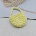 Detail of yellow handmade crochet mini bag charm with detailed woven knit texture - Light Yellow