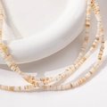 Holiday style multi-strand necklace featuring irregular 3mm natural beige shell beads - 1 Piece / Brown