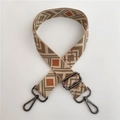 Detail of adjustable geometric jacquard strap with gunmetal hooks for crossbody bags - No.4 Green Brown + Gunmetal Buckle