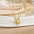 Detail of sun-shaped pendant necklace with cubic zirconia and You Are My Sunshine engraving - Gold Sunshine Opening Pendant Necklace XL0482