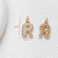 Macro view of gold letter R pendant with cubic zirconia and dimensions 30mm by 17mm - Letter R