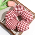 Detail of a large red and white gingham floral scrunchie on a wooden display tray - Large Red Checkered (Approx. 14.5cm)