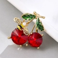 Detailed close-up of cherry brooch with red crystals, green enamel leaf and tiny bee with pearl - Cherry with Bee-XD10460