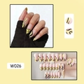 Close-up of almond shaped press-on nails with yellow French swirls and pink base - W026 Yellow Black Lines