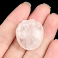 Pink rose quartz cat paw crystal carving held on fingertips for size scale - White Crystal