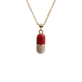 Gold chain necklace with red enamel and zircon pill pendant on white background - O-chain / Red