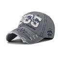 Detail of vintage washed grey cotton baseball cap with 85 embroidery and distressed brim - Adjustable / 1985 Grey