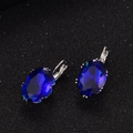 Detailed macro view of lever-back earrings with large oval blue zircon on dark texture - Blue (Oval)