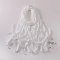 Detail of white satin hijab featuring elegant hand-set rhinestone flower embellishments - White