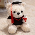 Cream teddy bear plush wearing a black graduation cap and gown with a diploma - White Graduation Bear