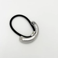 Detail of minimalist hair tie with silver curved metal piece on a black elastic band - Curved Mirror / Silver