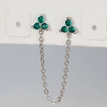 Macro detail of silver tassel chain earrings with three green cubic zirconia floral studs - Silver Green Rhinestone