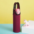 Macro view of burgundy neoprene bottle sleeve with black handle and buckle on a colorful wall - Burgundy