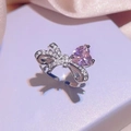 Adjustable silver bow ring featuring a pink heart stone and sparkling white crystals - Ring