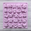 Detailed top view of a pink silicone mold with 25 unique Christmas holiday shapes - Purple