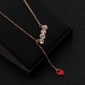 Macro shot of 18K rose gold 314 pendant with red heart on a black display base - 1314 Red Heart Style / Rose Gold