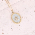 Macro detail of a gold oval pendant with light blue enamel and a central zircon star - Woven Border Light Blue Star Oval Style (5#)