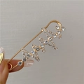 Macro detail of gold-plated safety pin brooch with sparkling rhinestones for waist adjustment - EKG Zigzag Wave Style (Gold)