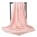 Pink satin square scarf featuring cherry and paisley prints hanging on a black metal frame - Pink Cherry Paisley