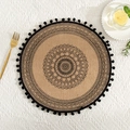 Detailed top view of a round jute placemat with black mandala pattern and fringe trim - Black Pom-poms Pattern 2