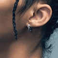 Silver thorn hoop earrings with woven design worn by a model in a close-up lifestyle shot - Vine Ear Buckle