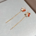 Macro shot of gold-plated flower tassel earrings with red enamel and sparkling zircons - Flower Tassel Style / Ear Line - Gold - Red (Real Gold Plated)
