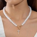 Detail of elegant pearl necklace featuring gold toggle clasp and sparkling cross pendant - Gold OT Buckle Cross Pearl Necklace