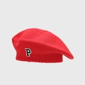 Close-up of red chunky knit beret with a black and white embroidered P letter patch - Red