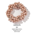 Elegant pink pearl bead hair tie on a white textured background for ponytails - 3119 Champagne