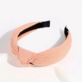 Cross-knot knitted wide headband in peach pink fabric with a pleated texture finish - Light Orange