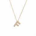 Close-up of gold plated letter F pendant with shimmering micro-pave zircon crystals - Letter F